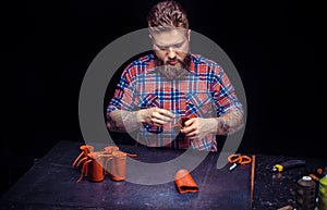 Leather Currier producing a leatherwork at his workshop