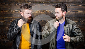 Leather fashion menswear. Men brutal bearded hipster posing in fashionable black leather jackets. Handsome stylish and