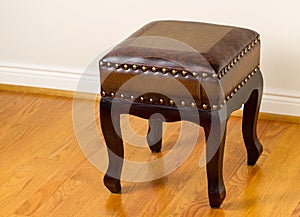 Leather footstool on traditional Oak floors