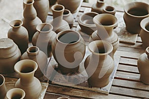 Leather hard handcraft clay pots waiting for dry and bisque fire in pottery process