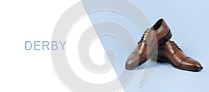 Leather male derby shoes isolated on blue background