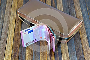 Leather mens open wallet with Euro and dollar banknotes bills