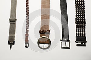 Leather and metal belts isolated on a white background