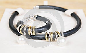 Leather necklace and bracelet with pearl. photo