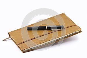 Leather notebook and pen isolated