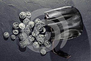 Leather pouch full of ancient silver coins