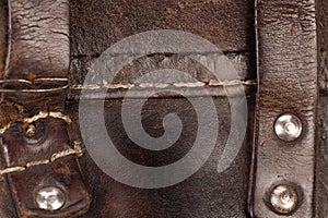 Leather product with rivets and seam