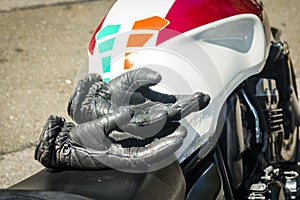 Leather Rider`s Gloves on saddle of Motorbike