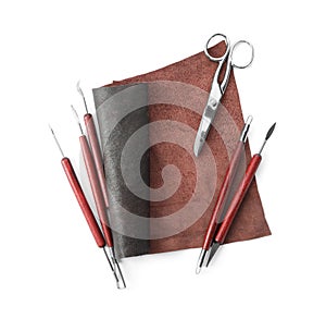 Leather sample and craftsman tools isolated on white