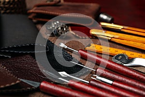 Leather samples and tools on brown table