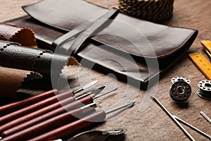 Leather samples and tools on brown table