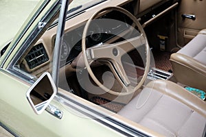 Leather seats and the wheel of a beautiful green retro car