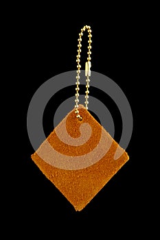 Leather shape sample tag on small chain, isolated on black