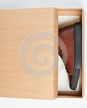 Leather shoes in half closed box