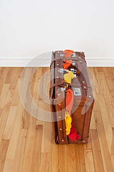 Leather suitcase with too much clothing