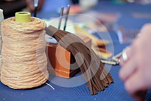 leather thread tassel craft DIY instrument tool. craftsman working desk