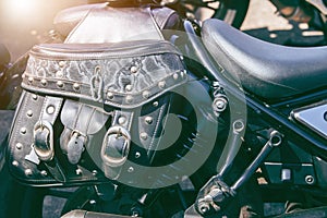 Leather travel bag on a motorcycle. Motorbike parked on a street