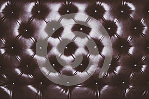 Leather upholstery texture of sofa. brown couch close up background