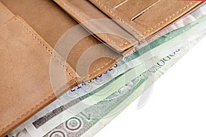 Leather wallet. Banknotes of 100 zloty, Polish money, on a white background