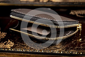 Leather wallet with a golden zipper close-up