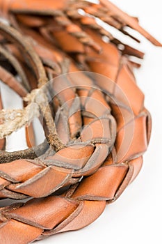 Leather whip isolated over white background closeup macro