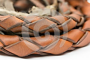 Leather whip isolated over white background closeup macro