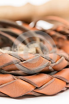 Leather whip isolated over white background closeup macro