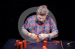 Leather Worker processes a workpiece from leather