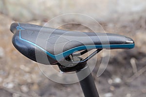 Leatherette saddle of modern bicycle, close-up in selective focus photo