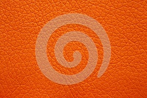 Leatherette texture in magnificent orange colour. Bright orange leather background. photo