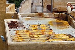 The leathers are dried on the roofs of the old tannery buildings in Fez. Morocco. The tanning industry in the city is considered