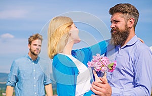 Leave past behind. Couple with bouquet romantic date. Ex husband jealous on background. Couple in love dating outdoor