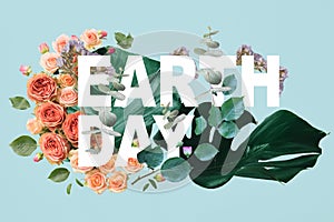 Leaves on blue background with flowers illustration and earth day lettering