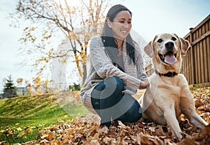 He leaves paw prints straight to my heart. an attractive young woman having fun with her dog on an autumn day in a