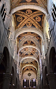 It leaves, towards the entrance, of the central frescoed nave of the cathedral of Lucca, illuminated by the light that enters thro photo