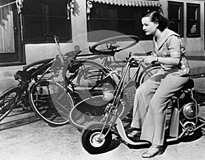 Leaving bicycles in the dust, a young woman fancies a miniature motorbike