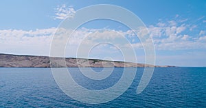 Leaving island Pag by ferry, rocky landscape