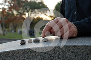 Leaving pebbles on headstone