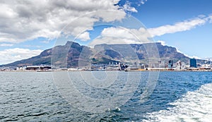 Leaving Table Bay and Table Mountain, Cape Town with wake on ocean photo