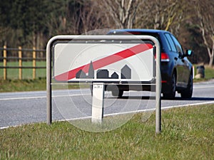 Leaving Town Sign at Road with Car