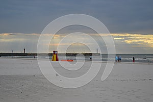 Leba beach afer rainy day, sun rays pass through the clouds, Poland