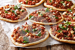 Lebanese Arab pizza with meat, tomatoes, spices and pine nuts closeup. horizontal