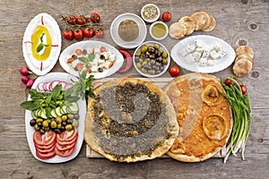 Lebanese food of Manakish, Lbaneh, cheeses, Vegetables and olives