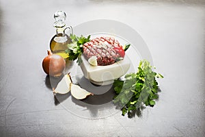 Lebanese food of Raw meat kibbe with oil and veggies photo
