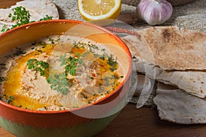 Lebanese hummus salad on rustic wooden table