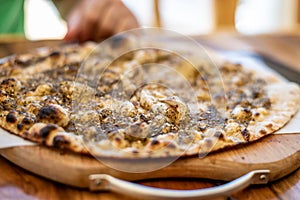 Lebanese Pie Zaatar on a wooden plate