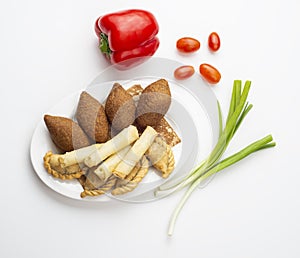 Lebanese Plate of Kebbeh , cheese rolls meat pie isolated on white