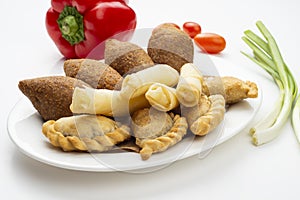 Lebanese Plate of Kebbeh , cheese rolls meat pie isolated on white
