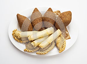 Lebanese Plate of Kebbeh, cheese rolls and meat pie isolated on white