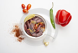 Lebanese starters of Sausage meat marinated, sausages fried in a metal pan isolated on white photo